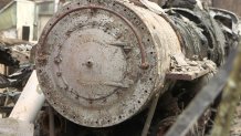 An incinerated locomotive that was originally built for the 1915 Pan Pacific Exposition sits in a field of debris where the CZU Lightning Complex Fire ripped through Davenport.