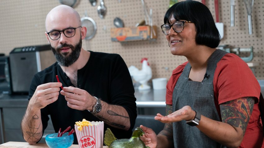 Andrew Rea, founder of the Binging with Babish network, left, tastes a beet parsnip licorice created by chef Sohla El-Waylly