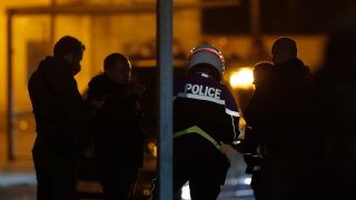 French police officers gather outside a high school after a history teacher who opened a discussion with students on caricatures of Islam's Prophet Muhammad was beheaded, Friday, Oct. 16, 2020 in Conflans-Saint-Honorine, north of Paris. Police have shot the suspected killer dead.
