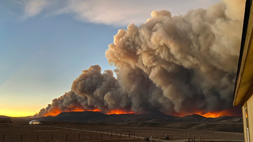 Large gray clouds of smoke seen in distance