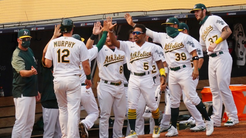 Sean Murphy of the Oakland Athletics returns to the dugout after scoring.