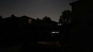 A suburban street in San Ramon, California is entirely dark except for a garage illuminated by a battery powered lantern during the Pacific Gas and Electric Public Safety Power Shutoff, October 9, 2019. (Photo by Smith Collection/Gado/Getty Images)