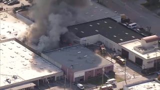 A fire burns at a building in the South San Francisco area.