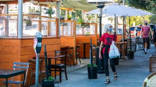 People pass by the parklet at Zazie restaurant in Cole Valley.