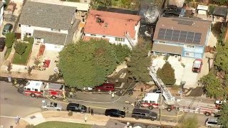 Firefighters work at the scene of a three-alarm fire in San Jose.