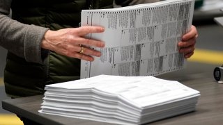 An election worker sorts mail-in ballots at the Multnomah County Duniway-Lovejoy Elections Building Monday, Nov. 2, 2020, in Portland, Ore.