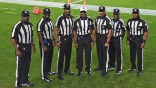 NFL officials, from left, umpire Barry Anderson, side judge Anthony Jeffries, down judge Julian Mapp, referee Jerome Boger, back judge Greg Steed, field judge Dale Shaw (104), line judge Carl Johnson (101) pose for a photo before an NFL football game between the Tampa Bay Buccaneers and the Los Angeles Rams Monday, Nov. 23, 2020, in Tampa, Fla. The game is the first in NFL history to feature an all African-American officiating crew.