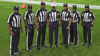 NFL officials, from left, umpire Barry Anderson, side judge Anthony Jeffries, down judge Julian Mapp, referee Jerome Boger, back judge Greg Steed, field judge Dale Shaw (104), line judge Carl Johnson (101) pose for a photo before an NFL football game between the Tampa Bay Buccaneers and the Los Angeles Rams Monday, Nov. 23, 2020, in Tampa, Fla. The game is the first in NFL history to feature an all African-American officiating crew.