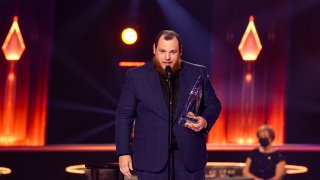 In this Nov. 11, 2020, file photo, Luke Combs accepts an award onstage during the 54th Annual CMA Awards at Nashville’s Music City Center in Nashville, Tennessee.