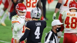 Quarterbacks Patrick Mahomes of the Kansas City Chiefs and Derek Carr of the Las Vegas Raiders fist bump.