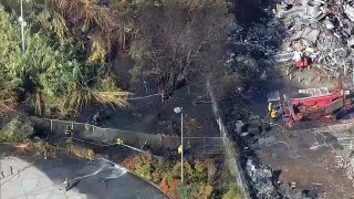 Crews work at the scene of a fire in East Oakland.