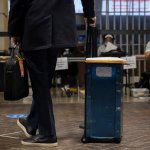 An election worker waits to secure ballots at Ford Field on November 3, 2020 in Detroit, Michigan.