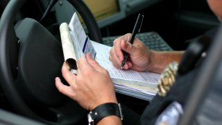 Police officer writing ticket