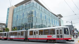 A San Francisco Municipal Railway (MUNI) train passes by the UCSF Mission Bay medical center in San Francisco, California, March 23, 2020. (Photo by Smith Collection/Gado/Getty Images)