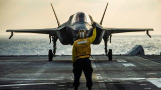 An F-35B Lightning II fighter aircraft with Marine Medium Tiltrotor Squadron (VMM) 265 (Reinforced), 31st Marine Expeditionary Unit (MEU), prepares to take off from the flight deck of amphibious assault ship USS America (LHA 6) prior to a strike exercise of an inflatable maritime target.