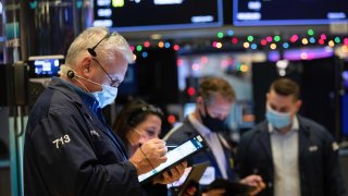 Traders work on the floor of the New York Stock Exchange.