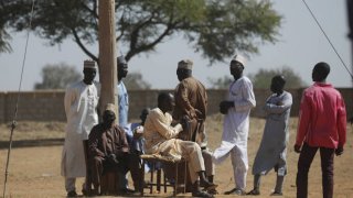 Parents wait after 300 boys were kidnapped in Nigeria.