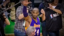 kobe bryant in lakers uniform waves to fans