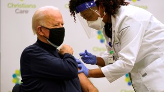 File Photo: President-elect Joe Biden (L) receives a COVID-19 Vaccination from nurse practitioner Tabe Masa at ChristianaCare Christiana Hospital on December 21, 2020 in Newark, Delaware..