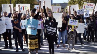 Google employees hold signs during a walkout to protest how the tech giant handled sexual misconduct in Mountain View, California, U.S., on Thursday, Nov. 1, 2018.