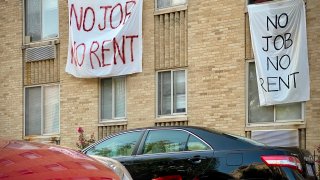 Banners against renters eviction reading no job, no rent is displayed on a controlled rent building in Washington, DC on August 9, 2020.