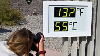 A photographer takes a picture of the thermometer reading 132 degrees Fahrenheit (55.5 Celsius) at the Furance Creek Visitors Station in Death Valley National Park, California, August 17, 2020.