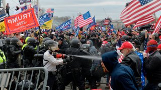 Trump supporters clash with police and security forces as they try to storm the US Capitol