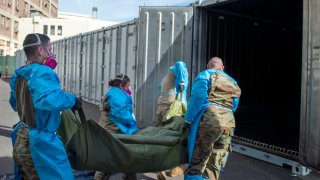 National Guard members assisting with processing COVID-19 deaths, placing them into temporary storage at the medical examiner-coroner's office in Los Angeles