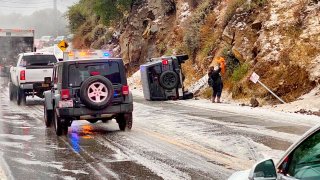 First responders work the scene of an accident after a hail storm on Malibu Canyon Road in Malibu, California, Jan. 23, 2021.