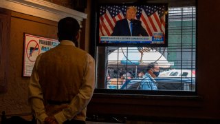US President Donald Trump is displayed on a television screen at a restaurant in Caracas, Venezuela, on November 4, 2020, amid the COVID-19 coronavirus pandemic.