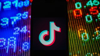 In this photo illustration, a TikTok logo seen displayed on a smartphone.