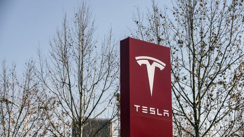 Signage at a Tesla Inc. showroom in Shanghai, China, on Friday, Jan. 8, 2021. Tesla customers in China wanting to get the new locally made Model Y are facing a longer wait, signaling strong initial demand for the Shanghai-built SUV.