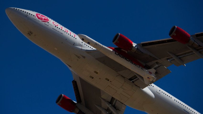 File Image: The Virgin Orbit “Cosmic Girl” – a modified Boeing Co. 747-400 carrying a LauncherOne rocket under it’s wing – takes off for the Launch Demo 2 mission from Mojave Air and Space Port on January 17, 2021 in Mojave, California. – The LauncherOne rocket, which will release from the wing of the Boeing 747 before ignition, contains small research satellites, known as CubeSats for NASA’s Educational Launch of Nanosatellites (ELaNa) 20 mission developed by nine research universities and a NASA center. (Photo by Patrick T. FALLON / AFP) (Photo by PATRICK T. FALLON/AFP via Getty Images)