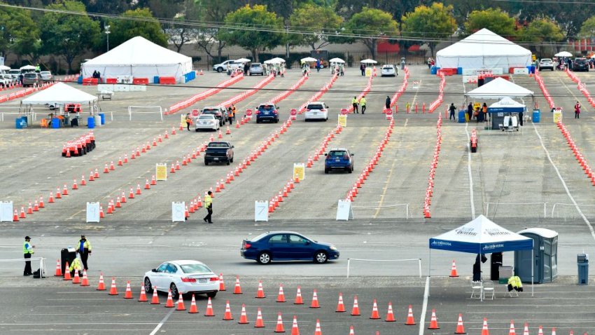 People arrive in their vehicles to receive Covid-19 vaccines at the Fairplex in Pomona, California on January 22, 2021, one of five mass Covid-19 vaccine sites opened across Los Angeles County this week. – A severely limited supply of Covid-19 vaccines, which only recently became available to the population, could mean people won’t be fully inoculated until 2022 unless the supply of the vaccine increases. (Photo by Frederic J. BROWN / AFP) (Photo by FREDERIC J. BROWN/AFP via Getty Images)