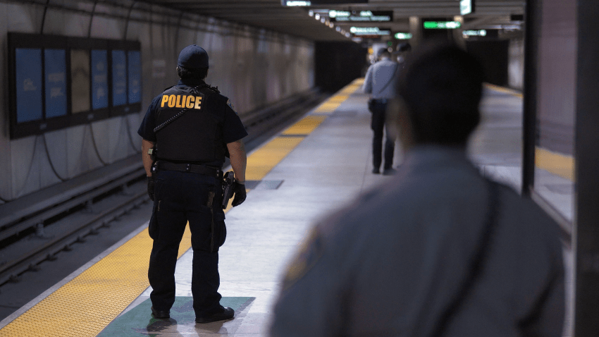 BART police officers and fare inspectors await the next train as part of an ongoing fare check operation at the Embarcadero Station in San Francisco