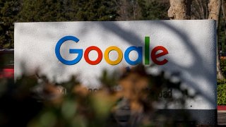 Signage at an entrance to a building on the Google campus in Mountain View, California, U.S., on Wednesday, Dec. 16, 2020. On Wednesday, Texas Attorney General Ken Paxton filed an antitrust lawsuit against Alphabet Inc.'s Google. At its center is a bold claim: Google colluded with archrival Facebook Inc. in an illegal deal to manipulate auctions for online advertising, an industry the two companies dominate.