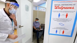 A man waits for pharmacist Joe Borge in Danvers, MA on Feb. 1, 2021. On the first day of Phase 2 of the COVID-19 rollout, seniors, 75 and over, get vaccinated in the Walgreens Pharmacy, at 107 High Street, in Danvers.