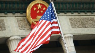 The U.S. flag flies at a welcoming ceremony between Chinese President Xi Jinping and U.S. President Donald Trump in 2017.