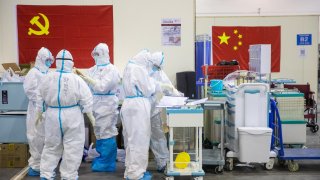 This file photo taken on Feb. 17, 2020 shows medical staff members working at an exhibition center converted into a hospital in Wuhan in China’s central Hubei province.