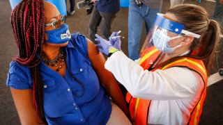 Letetsia A. Fox, Chapter President Los Angeles 500 of the California School Employees Association receives her first COVID-19 Moderna vaccination shot from registered nurse Sosse Bedrossian, director of nursing services for LAUSD.