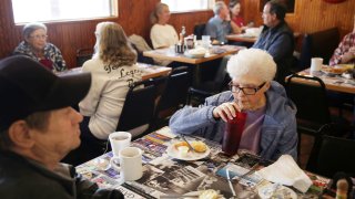 People eat breakfast at Bill Smith’s Cafe, after Texas Governor Greg Abbott issued a rollback of coronavirus disease (COVID-19) restrictions in McKinney, Texas, March 10, 2021.