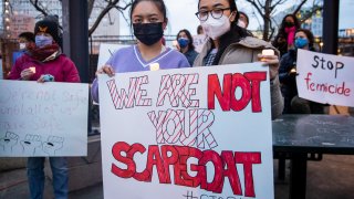 Alexis Lin (L) and Rania Bakrhi attend a vigil in solidarity with the Asian American community after increased attacks on the community since the onset of the coronavirus pandemic a year ago, in Philadelphia, Pennsylvania, March 17, 2021.