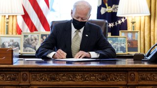 President Joe Biden signs the “Paycheck Protection Program (PPP) Extension Act of 2021” into law in the Oval Office at the White House in Washington, U.S., March 30, 2021.