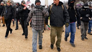 Proud Boys including Joseph Biggs, front left, walks toward the U.S. Capitol in Washington