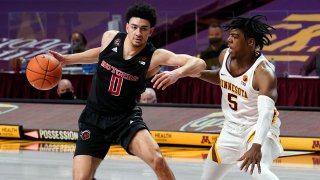 Rutgers' Geo Baker (0) tries to evade Minnesota's Marcus Carr (5) in the second half of an NCAA college basketball game, Saturday, March 6, 2021, in Minneapolis. Rutgers won 77-70.