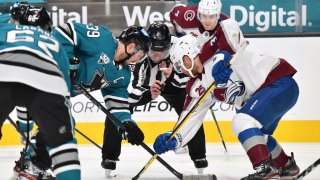 SAN JOSE, CA – MARCH 01: Logan Couture #39 of the San Jose Sharks takes a face-off against J.T. Compher #37 of the Colorado Avalanche at SAP Center on March 1, 2021 in San Jose, California. (Photo by Brandon Magnus/NHLI via Getty Images)