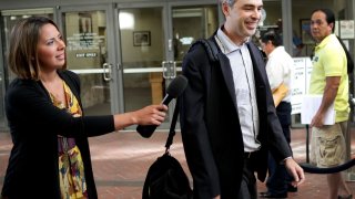 Larry Page, chief executive officer of Google Inc., right, speaks to the media while arriving at court in San Jose, California, U.S., on Monday, Sept. 19, 2011.