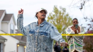 Shanise Washington reacts as investigators work at the scene where 15-year-old Ma’Khia Bryant was shot and killed by a police officer in Columbus, Ohio, April 20, 2021.