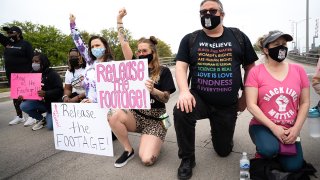 FILE - Demonstrators block bridge traffic during a protest march on April 24, 2021, in Elizabeth City, North Carolina.