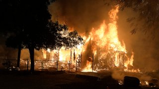 Home burning in fast-moving Lightning Complex Fire